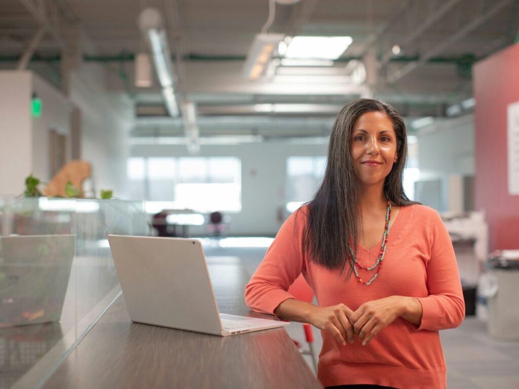 Business owner in an office with a laptop